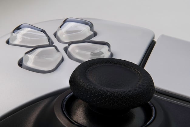 A close-up shot of a PlayStation 5 controller, focusing on the customizable buttons and adaptive triggers. The controller is being held by a person with an assistive device, demonstrating how the controller can be modified for easier use. The background shows a partially visible PlayStation 5 console.
