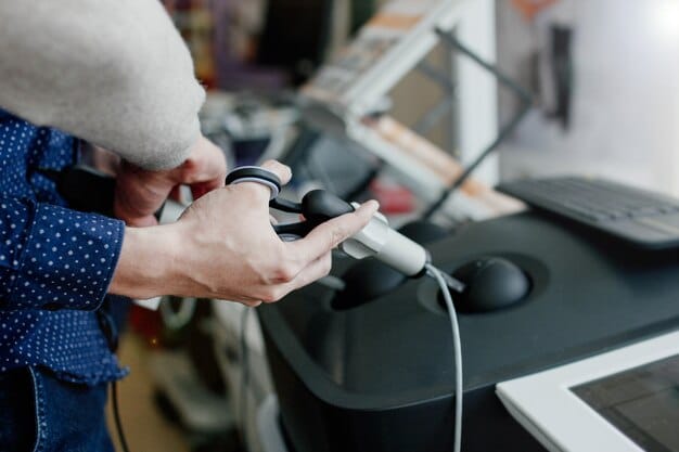 A technician working on the internal components of a PlayStation console, wearing an anti-static wrist strap. A variety of tools and spare parts are neatly organized on the workbench.