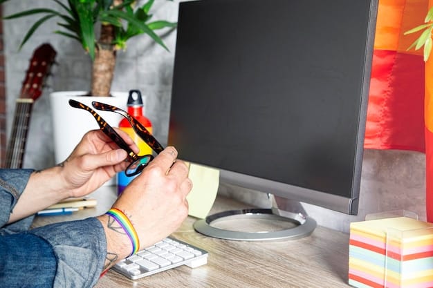 A close-up of someone using precision tools to carefully disassemble a game console, following a detailed online tutorial on a laptop screen in the background.