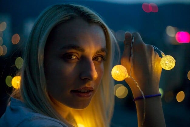 A close-up, intense portrait of Lucia from GTA VI, showing determination and street-hardened resilience in her eyes, with the faint glow of Vice City lights reflecting in the background.