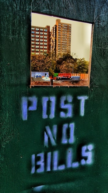 A close-up, highly detailed shot of a single, weather-beaten street sign in Vice City, peeling paint and rust visible, perhaps with a humorous or satirical graffiti tag nearby. Focus on texturing and aging.