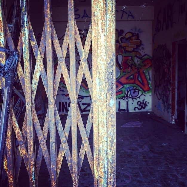 A close-up shot of a graffitied wall in a fictionalized version of Miami, with a faded 