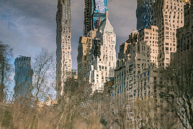 A contrasted image showing two distinct districts: one side with dilapidated buildings and graffiti art, representing a low-income area, and the other side with modern skyscrapers and clean streets, representing a business district. The contrast underscores economic disparity.
