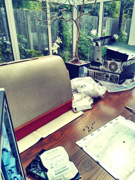 A snapshot of a cluttered desk in GTA 6, featuring items like a half-written letter, a worn photograph, a gun, and scattered bullets, symbolizing a character's troubled past and their involvement in dangerous activities.