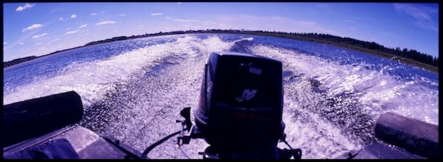 A close-up shot of water splashing realistically as a speedboat races through a canal in the GTA 6 trailer. Show the dynamic water physics and reflections.