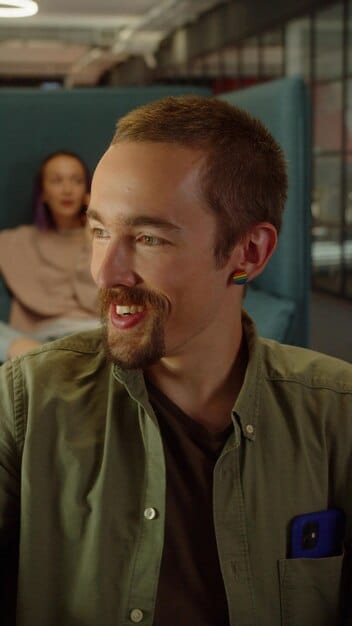 A close-up shot of a character's face during a conversation in GTA 6, emphasizing their facial expressions and body language. The background is blurred, focusing attention on the character's subtle cues and unspoken intent.